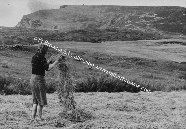 WOMAN SIFTING STRAW